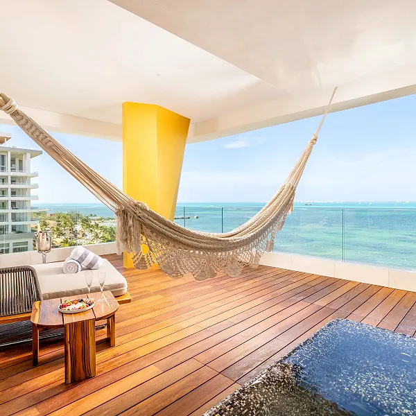 Luxurious corner suite with private balcony and ocean views at Hotel Mousai Cancun